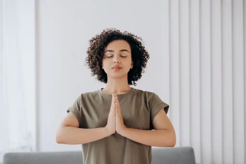 Woman practicing mindfulness meditation in living room