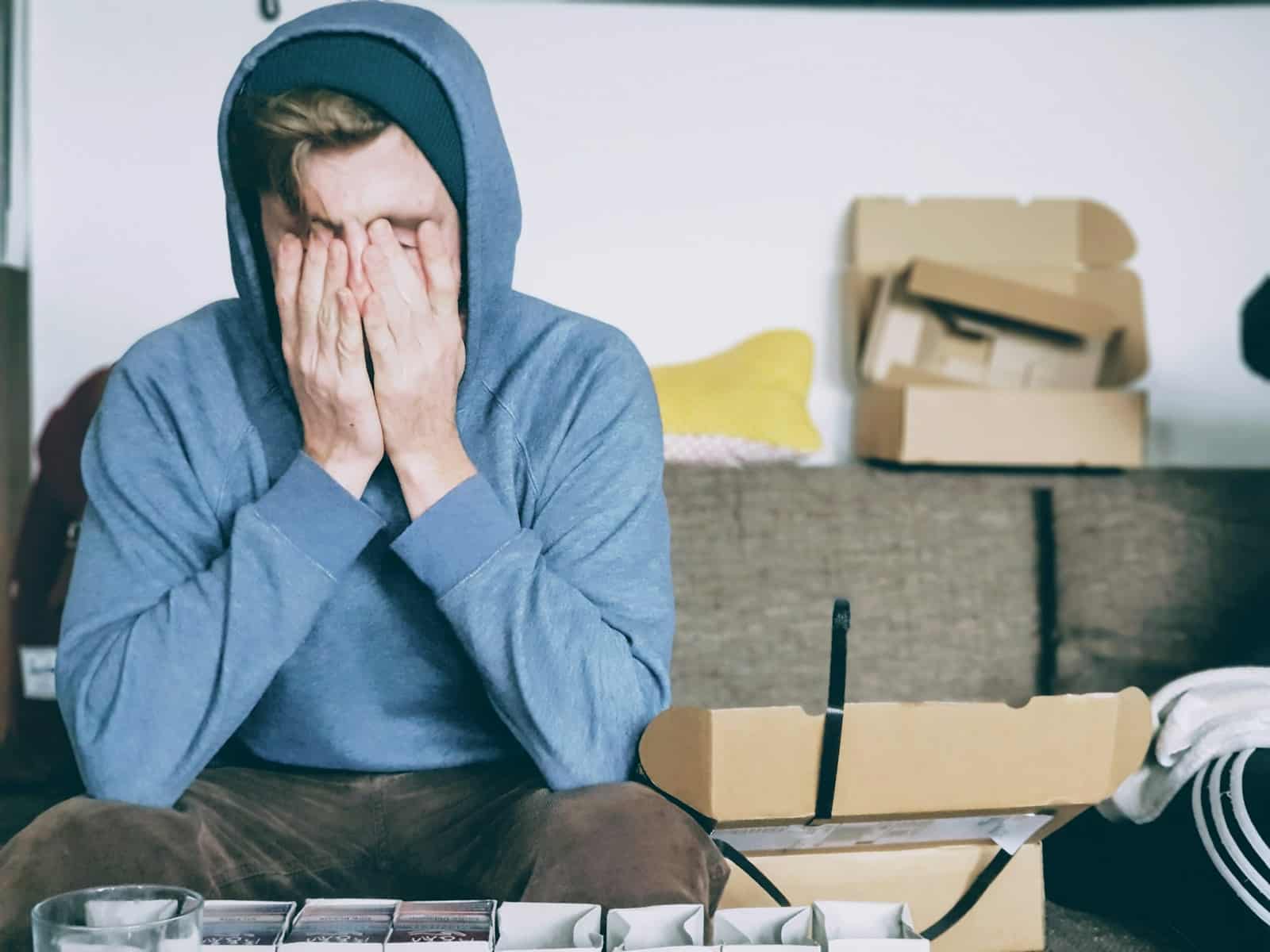 man covering face with both hands while sitting on bench.adhd burnout symptoms. adhd overthinking