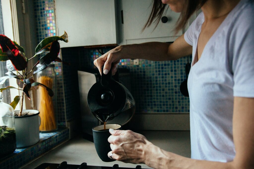 woman in white t-shirt holding black ceramic mug - adhd routine