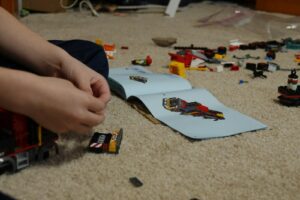 person holding yellow and black car toy - ADHD difficulty following instructions