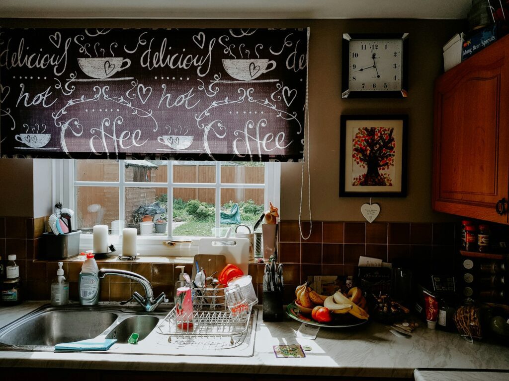 a kitchen sink under a window with a clock above it - adhd routines