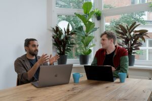 Photo by airfocus - Philanthropeak Coaching - Philanthropeak Coaching man in red and black crew neck t-shirt using silver macbook adhd coaching