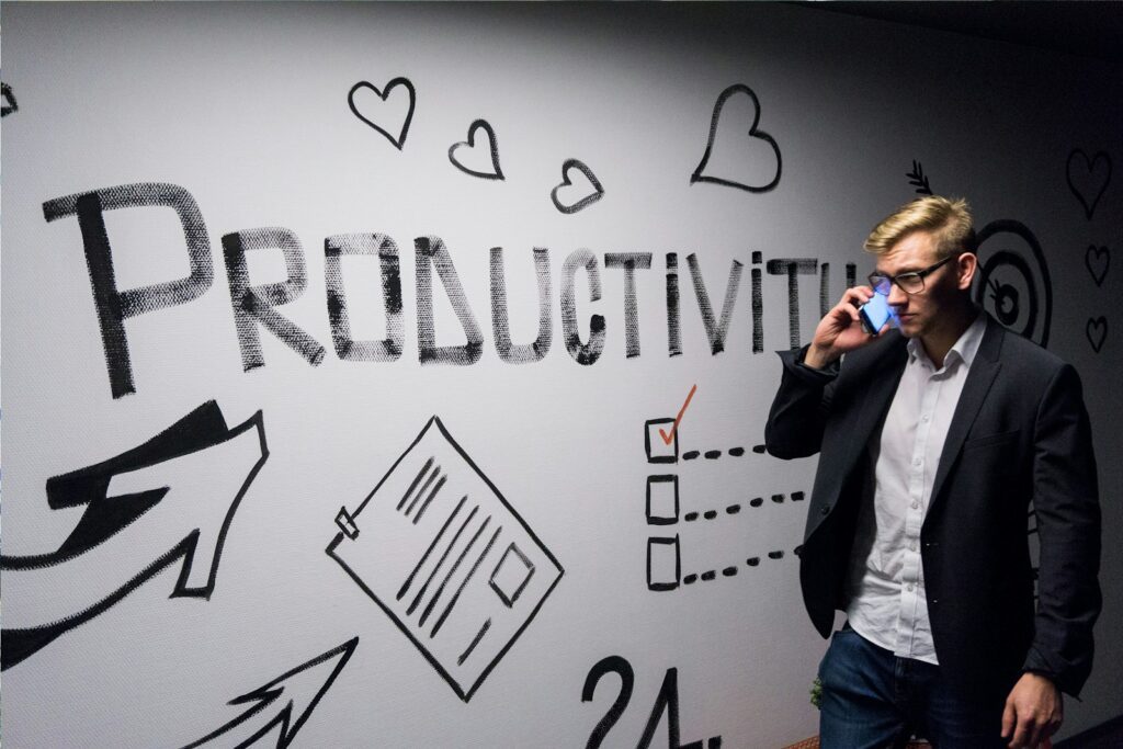 man holding smartphone looking at productivity wall decor adhd productivity business owners